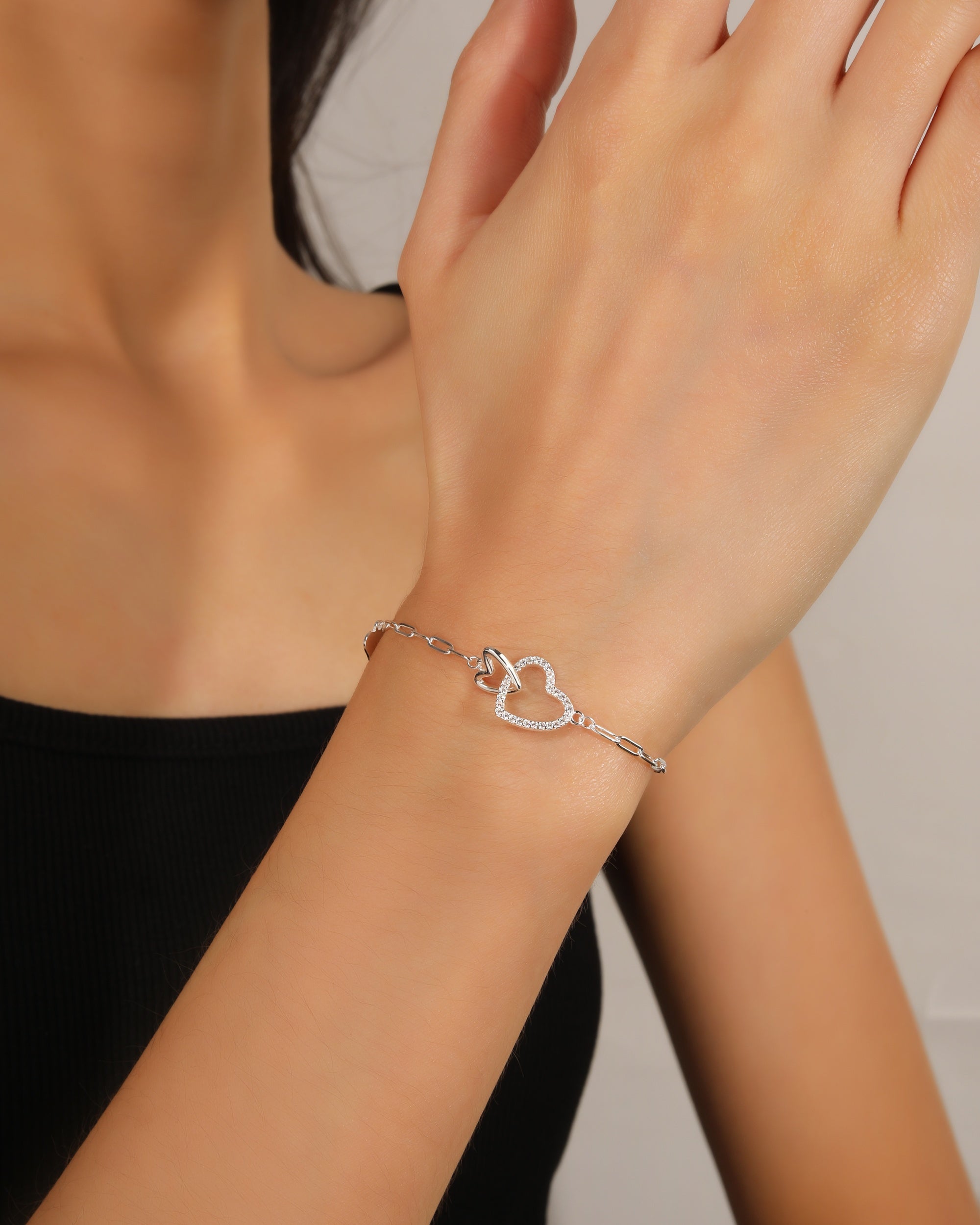 Pulsera de silueta de corazones entrelazados con circonia blanca 17+3cm en plateado