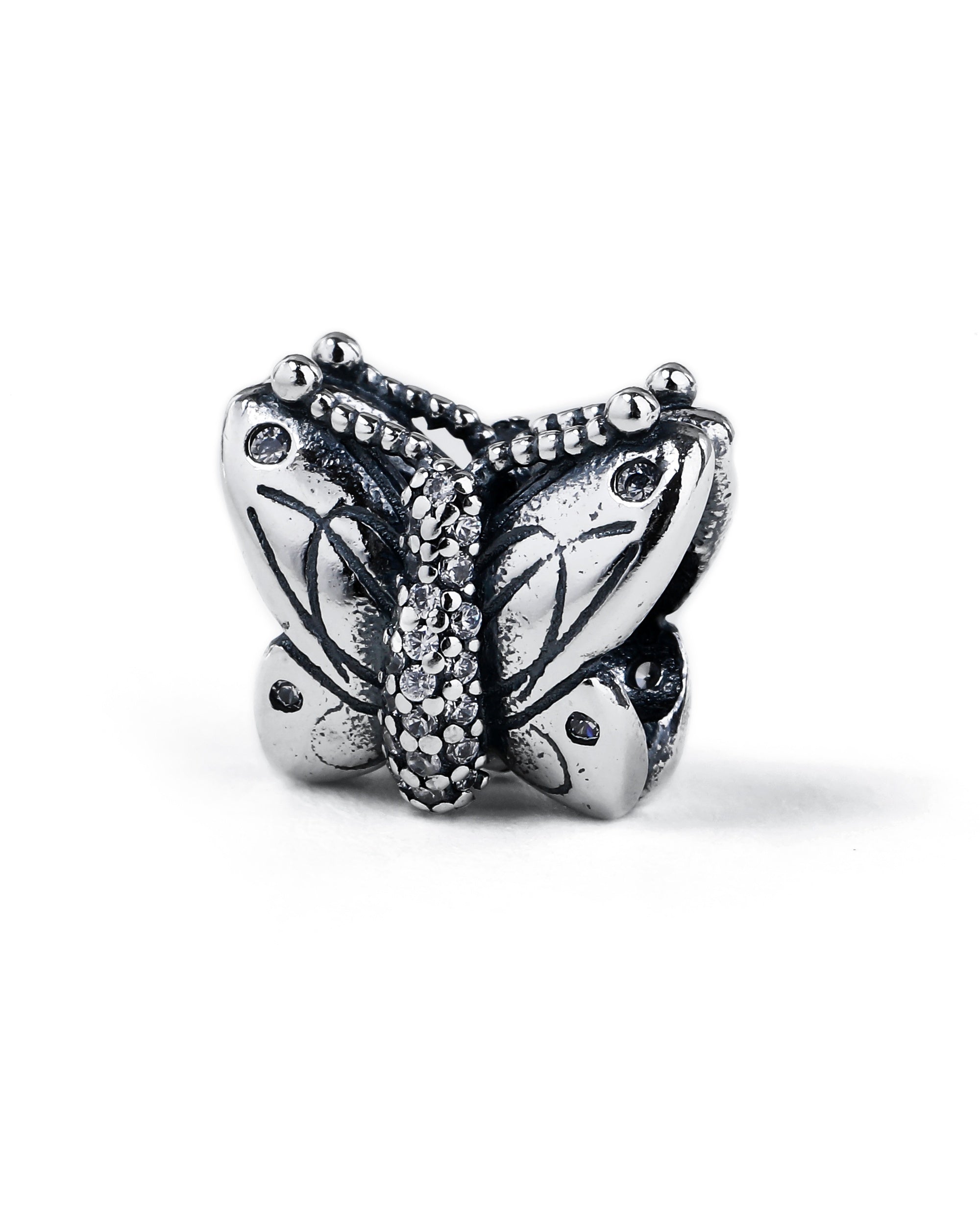 Charm separador de mariposa con circonia blanca en oxidada