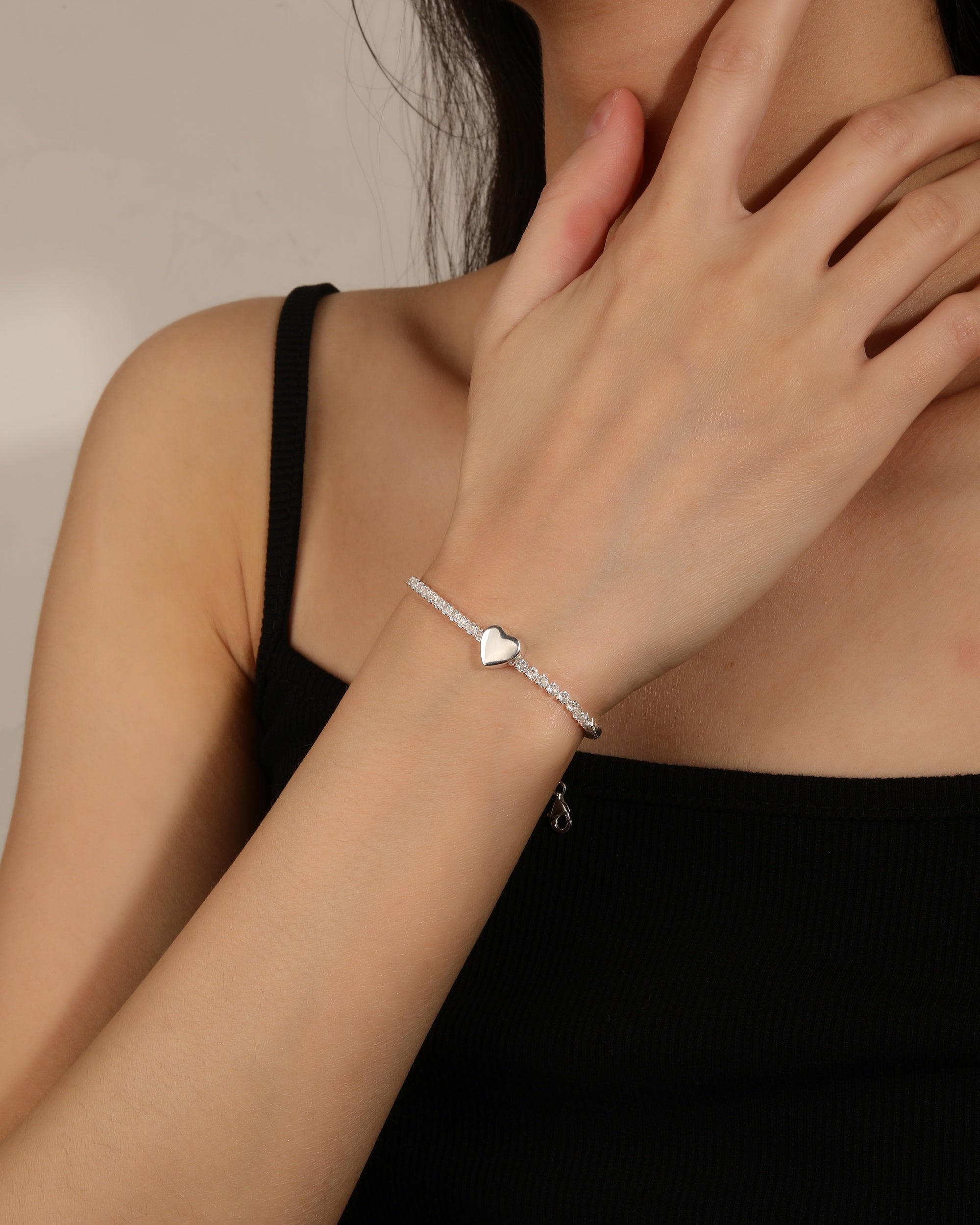 Pulsera de tenis con pasador de corazon liso y circonias blancas en plateado