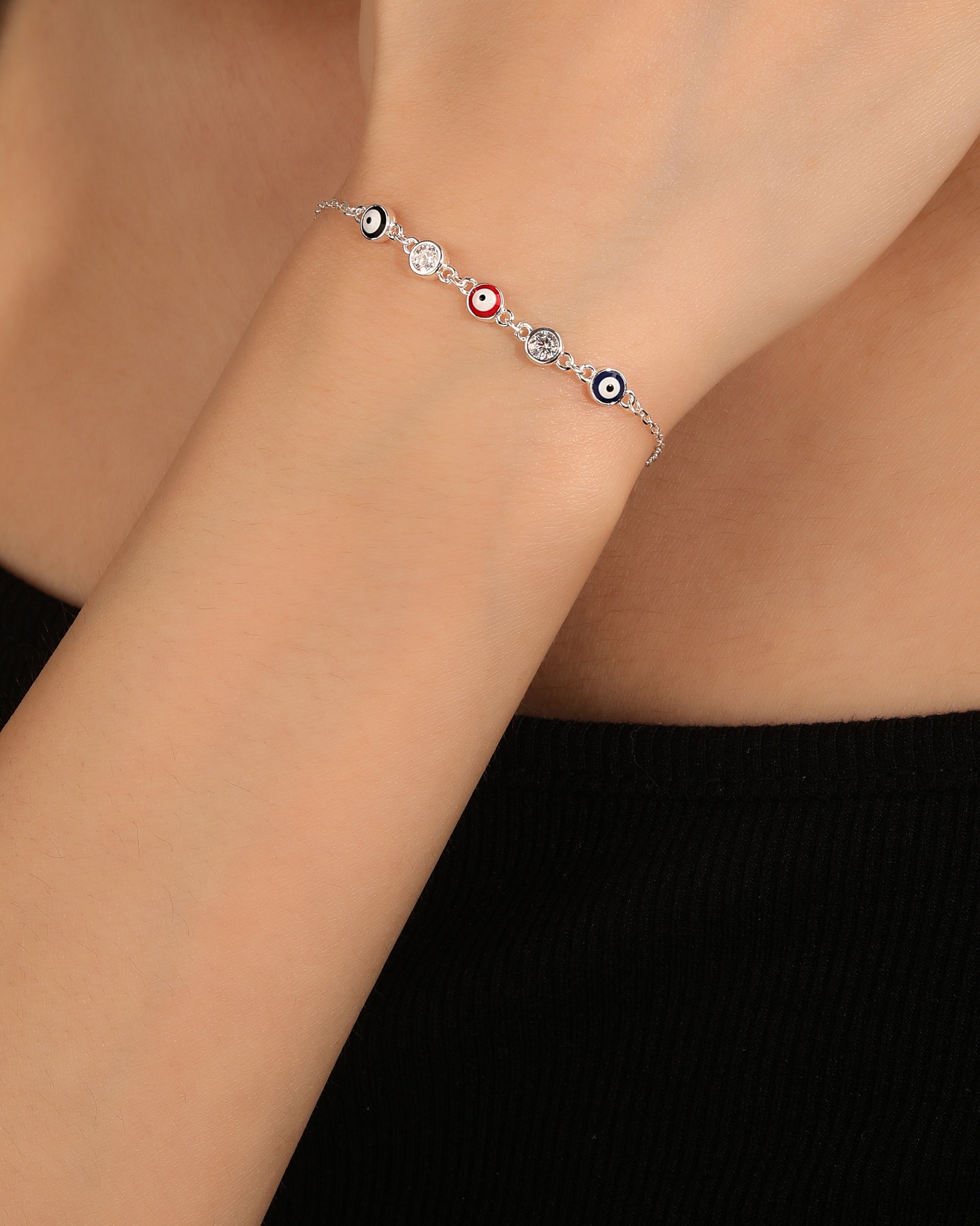 Pulsera sencilla con ojitos multicolor  y circonias 17+3cm en plateado