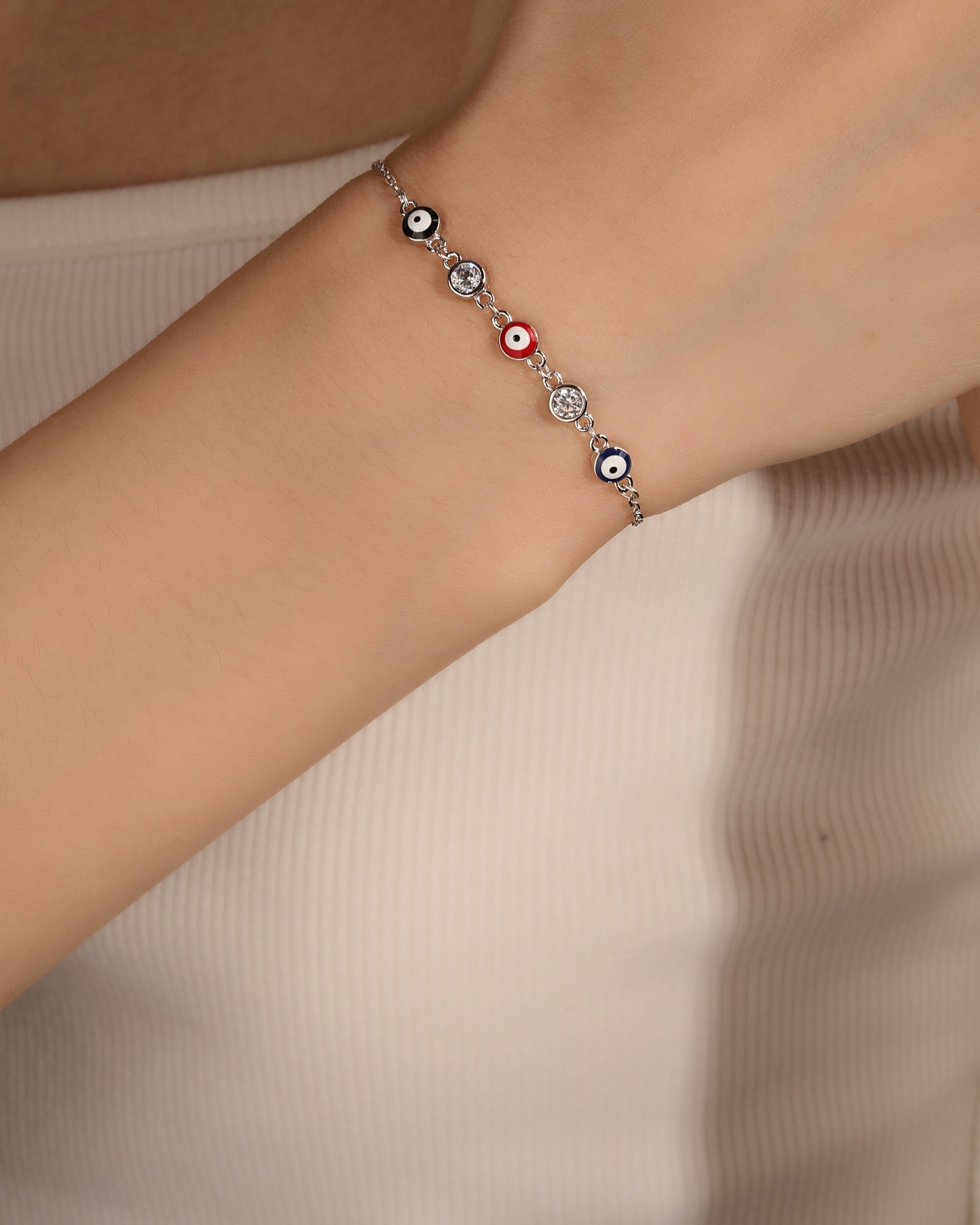 Pulsera sencilla con ojitos multicolor  y circonias 17+3cm en rodizado
